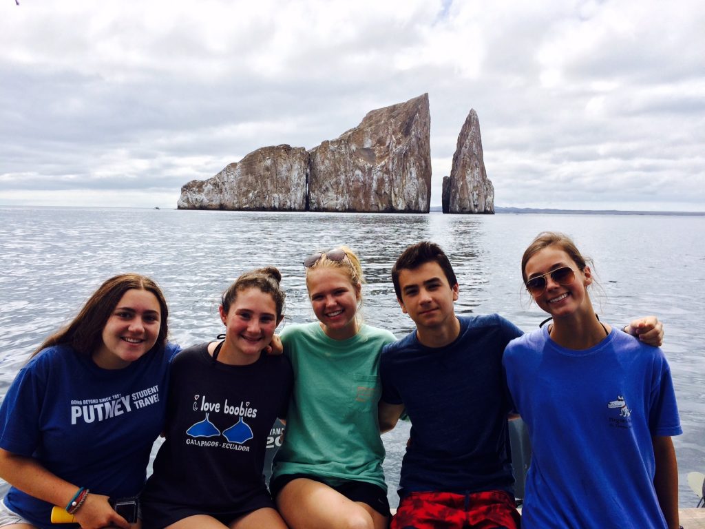 Stopping to watch bottlenose dolphins with Kicker Rock in the distance.
