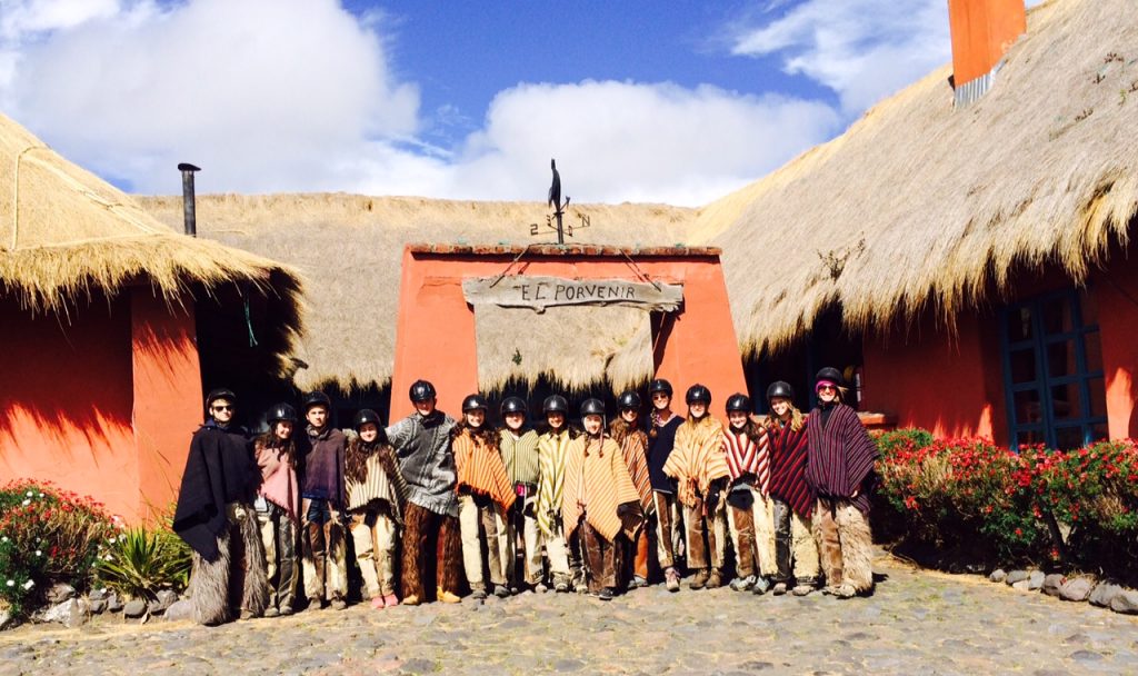 Wearing traditional ponchos and chaps for our páramo ride.